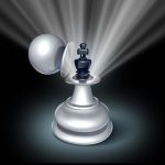 Chess pieces with a spotlight symbolise succession planning strategies and effective leadership transition.